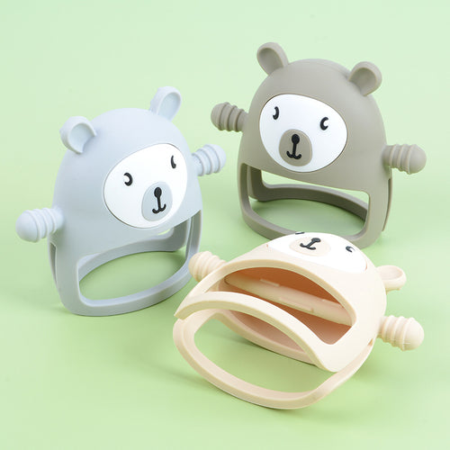 Three bear-shaped baby teething toys on a light green background