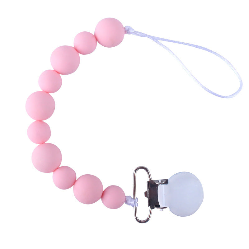 Pink silicone pacifier clip on a white background