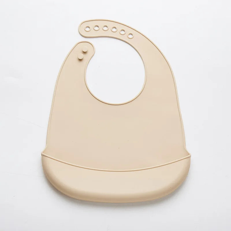 Beige silicone bib on a light gray background