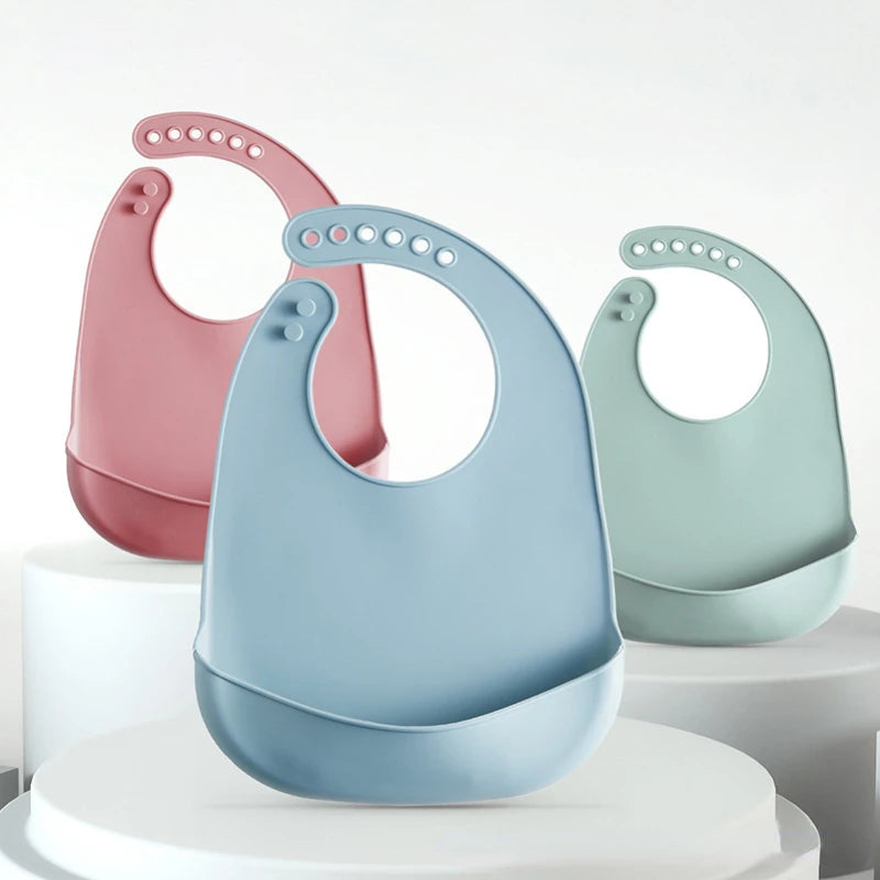 Three colorful baby bibs on a white background