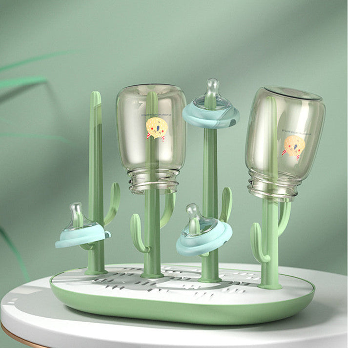 Baby bottle drying rack with bottles on a green background
