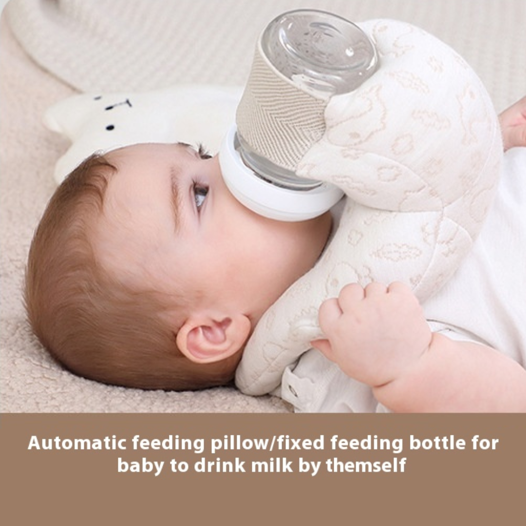 Baby lying on a white blanket with a bottle and pillow, text 'Automatic feeding pillow/fixed feeding bottle for baby to drink milk by themselves'.